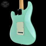 Turquoise electric guitar body with a visible brand logo in the corner.