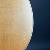 Close-up of a light natural wood grain surface with a thin dark edge against a dark navy background.