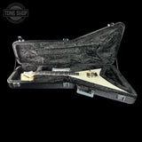 A white Fender electric guitar inside an open black hard case with a gray velvet-lined interior, shown against a solid black background. A 'TONE SHOP' watermark is visible in the top-left corner.