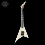 A white electric guitar with a distinctive angular body, black neck, and gold hardware, shown against a solid black background. A Tone Shop watermark is visible in the top-left corner.