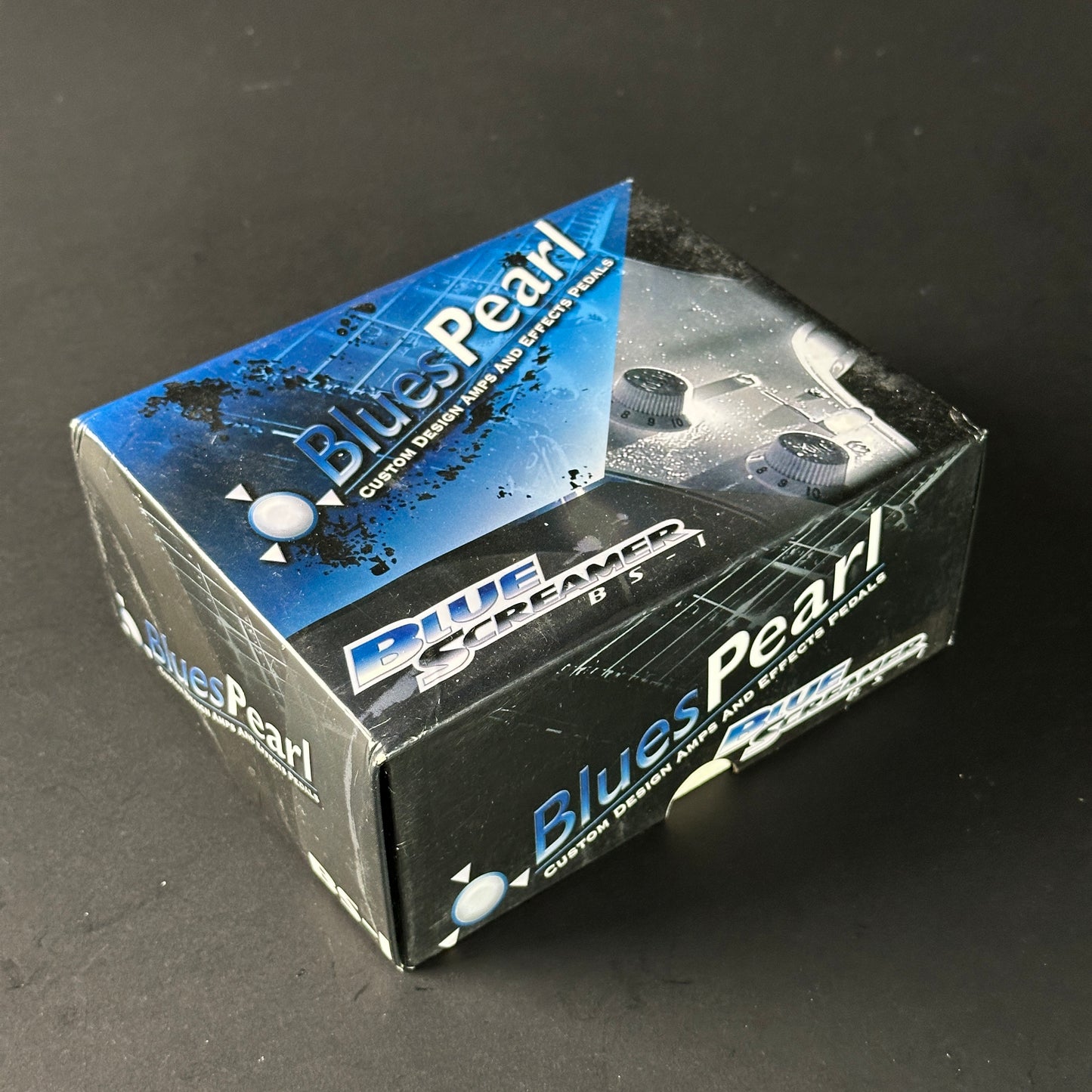 Blues Pearl audio effect pedal packaging on a dark background