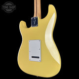 Yellow electric guitar with a visible brand logo on a black background