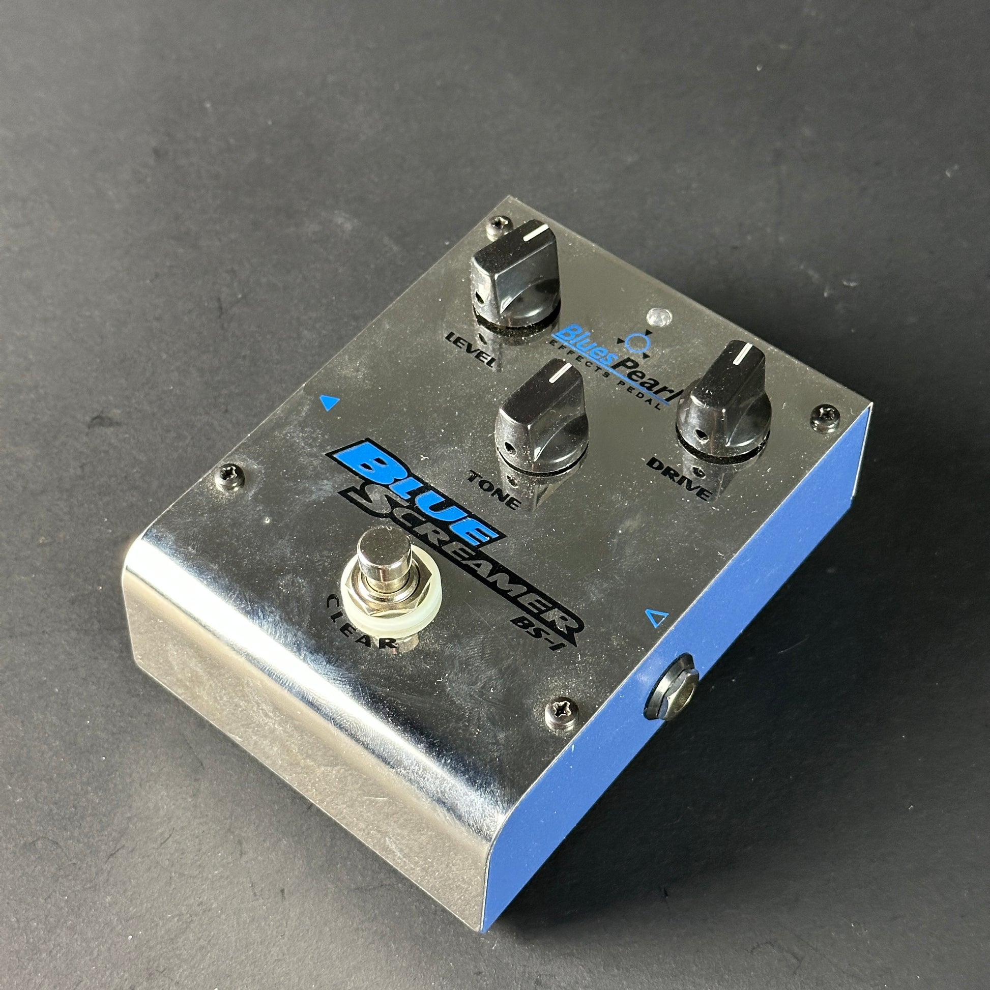 Guitar effects pedal with 'Blue Screamer' branding on a dark background