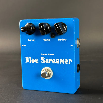 Blue Screamer guitar effects pedal with three knobs on a dark background