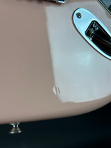 Close-up of a guitar with a visible brand logo on a dark background