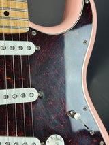 Close-up of a guitar's headstock and tuning pegs with a dark wood finish.