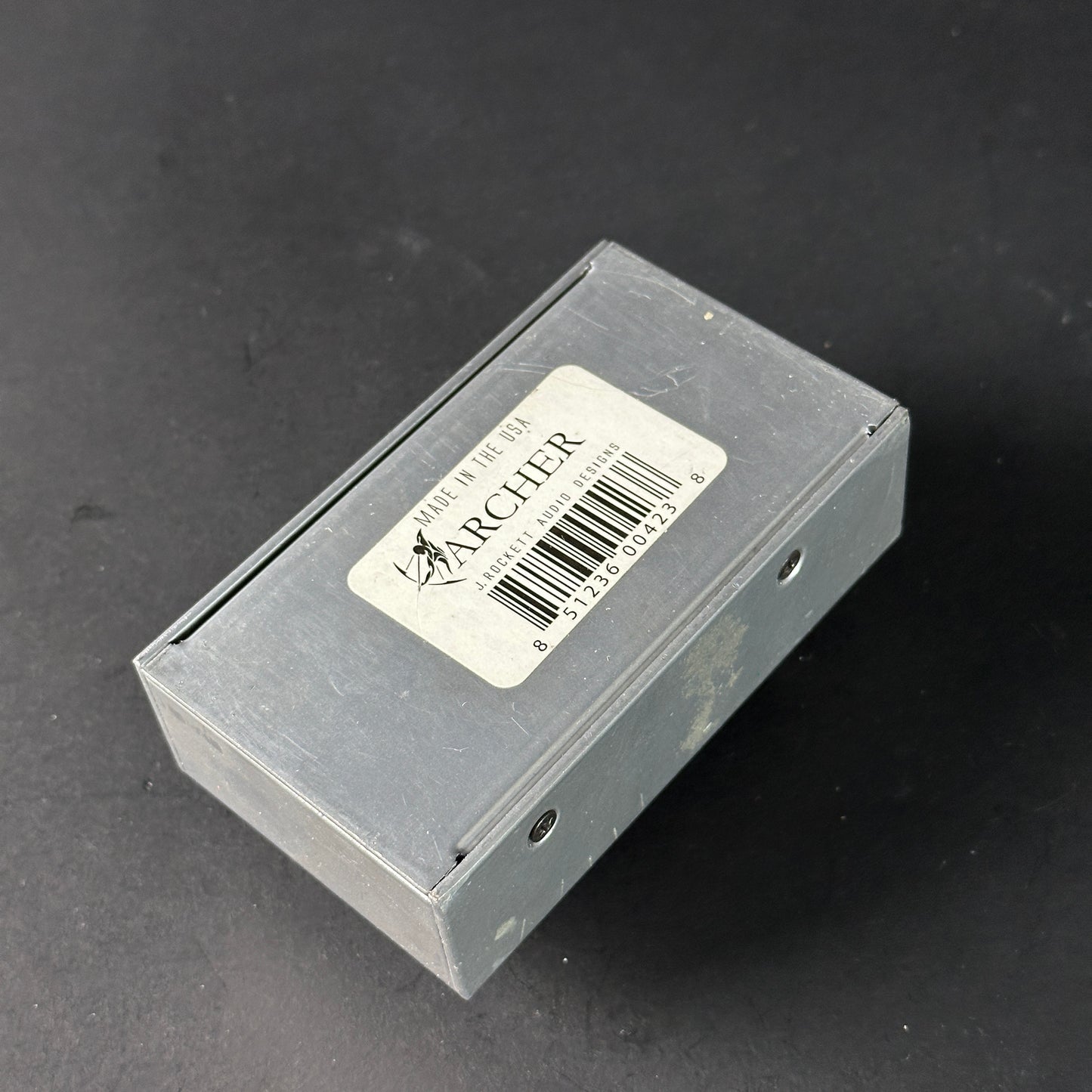 Small rectangular box with a label on a dark background
