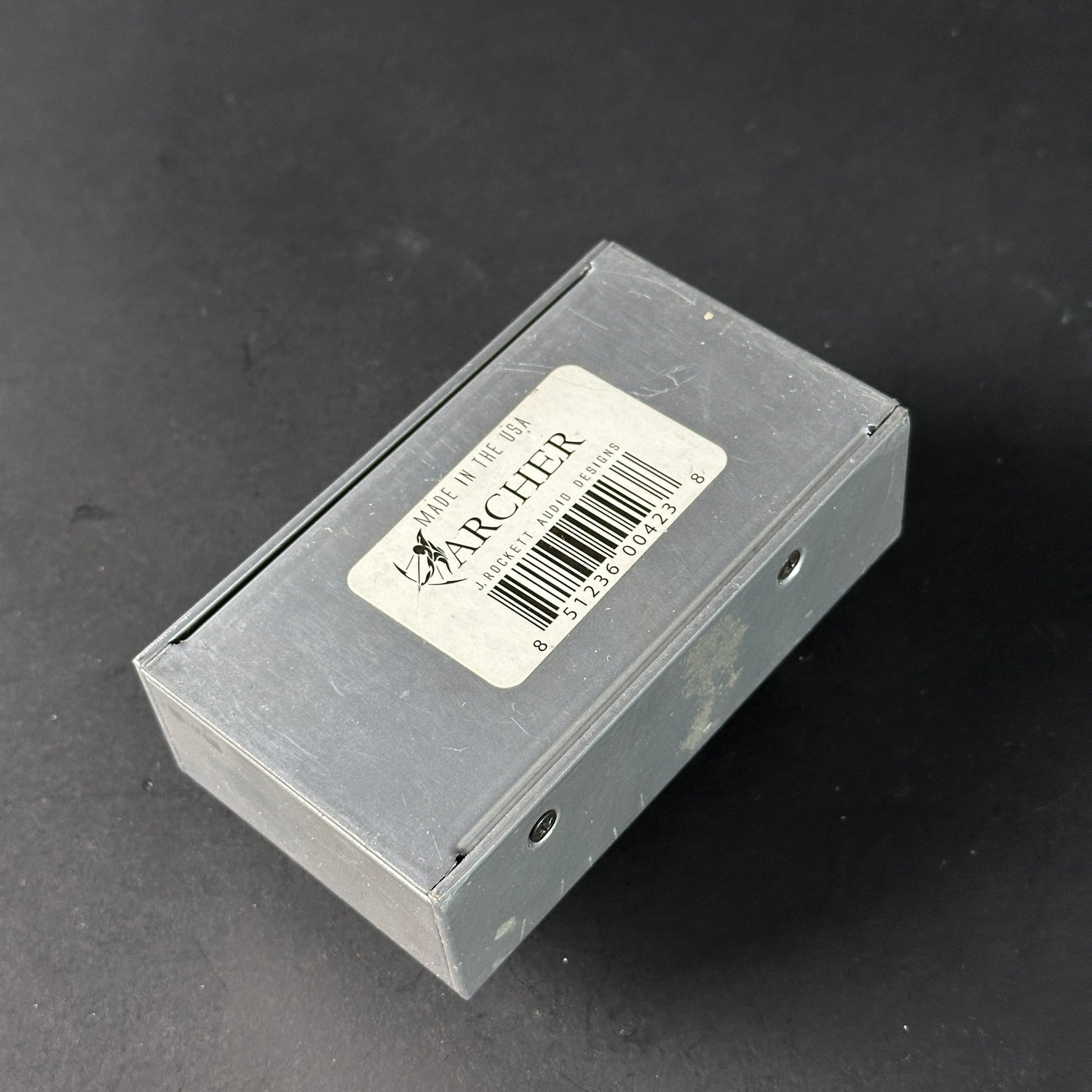 Small rectangular box with a label on a dark background