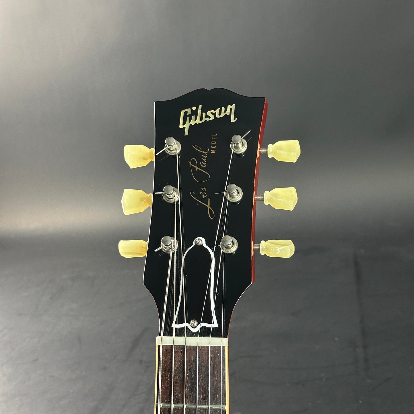 Gibson Les Paul guitar headstock on a dark background