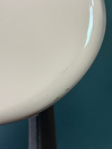 Close-up of a beige ceramic bowl with a blurred background