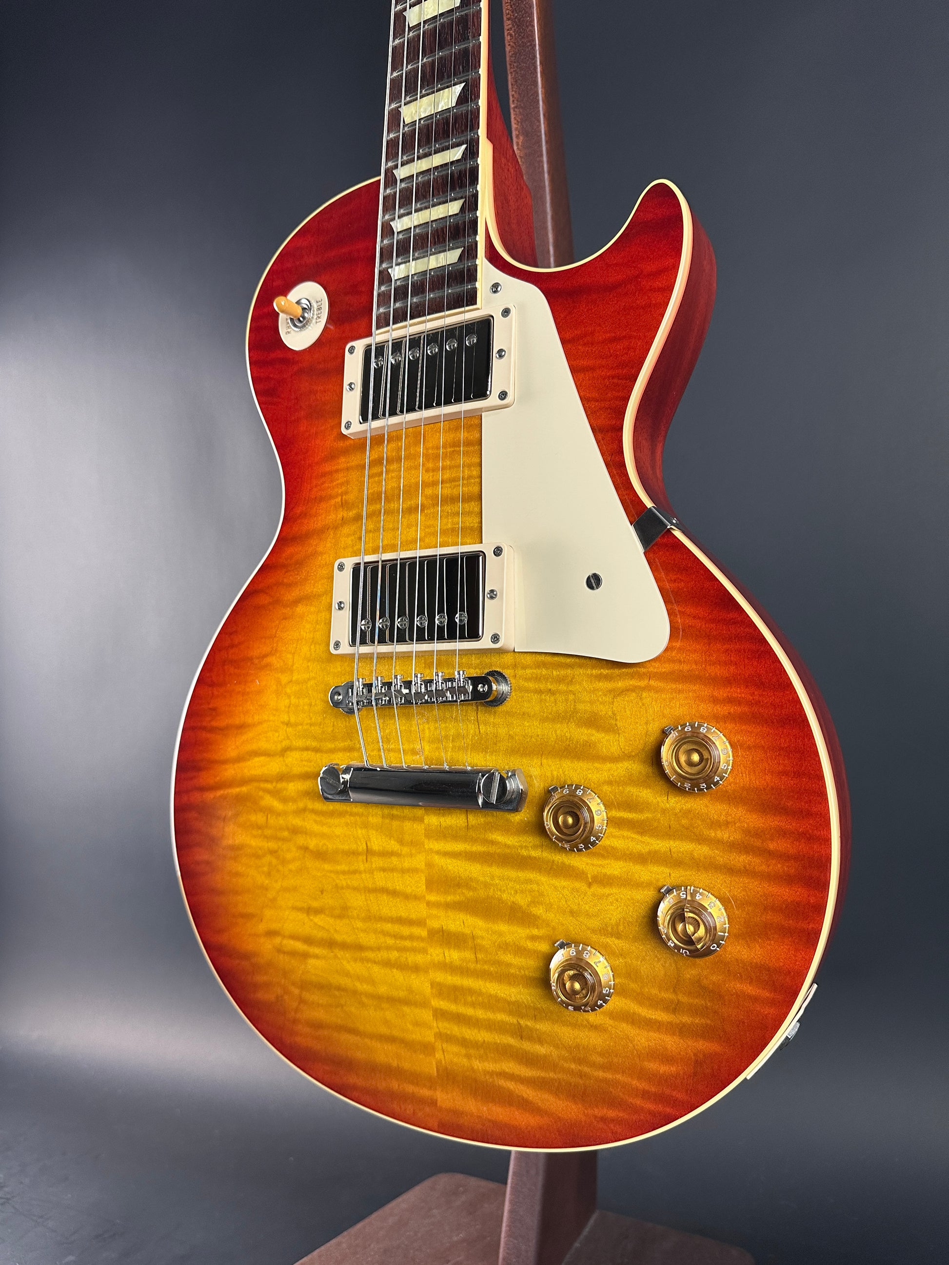 Gibson Les Paul guitar with a sunburst finish on a dark background