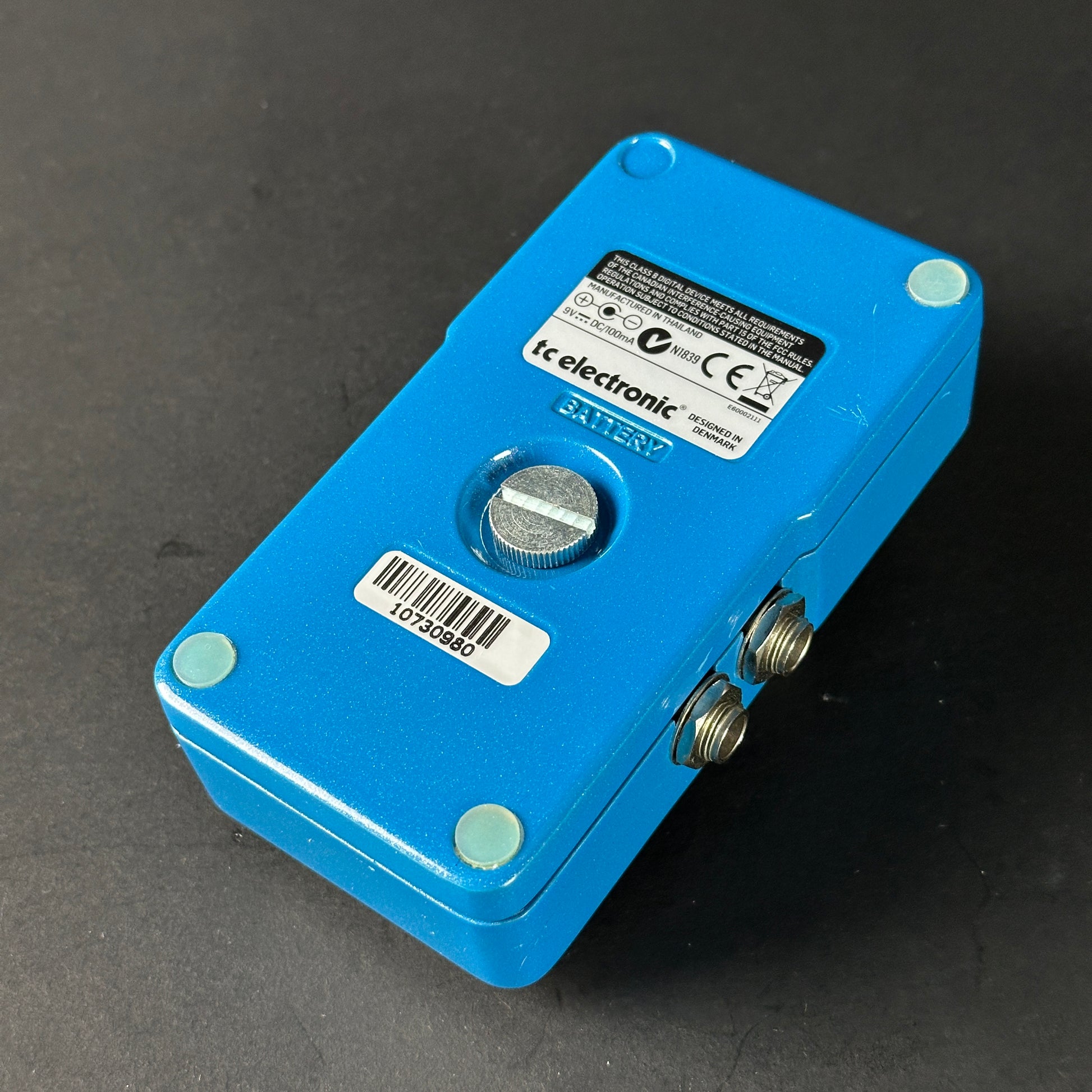 Blue electronic device with a label on a dark background