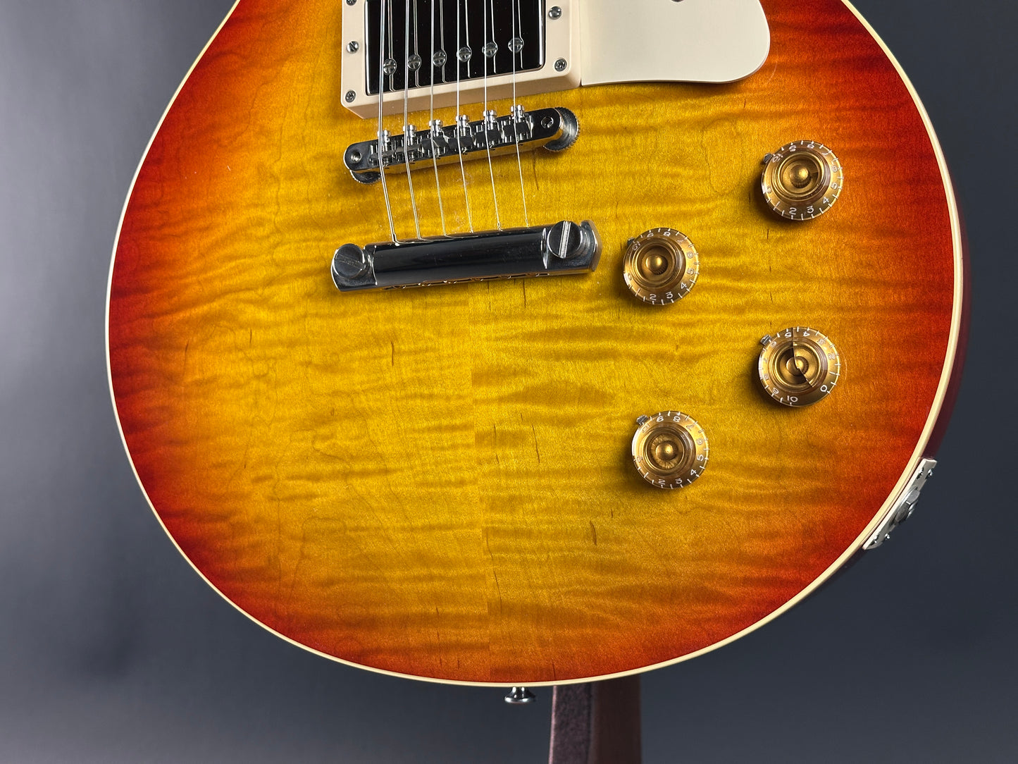 Close-up of a sunburst electric guitar with a dark background