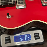 Collings 470-JL Red on scale displaying weight.