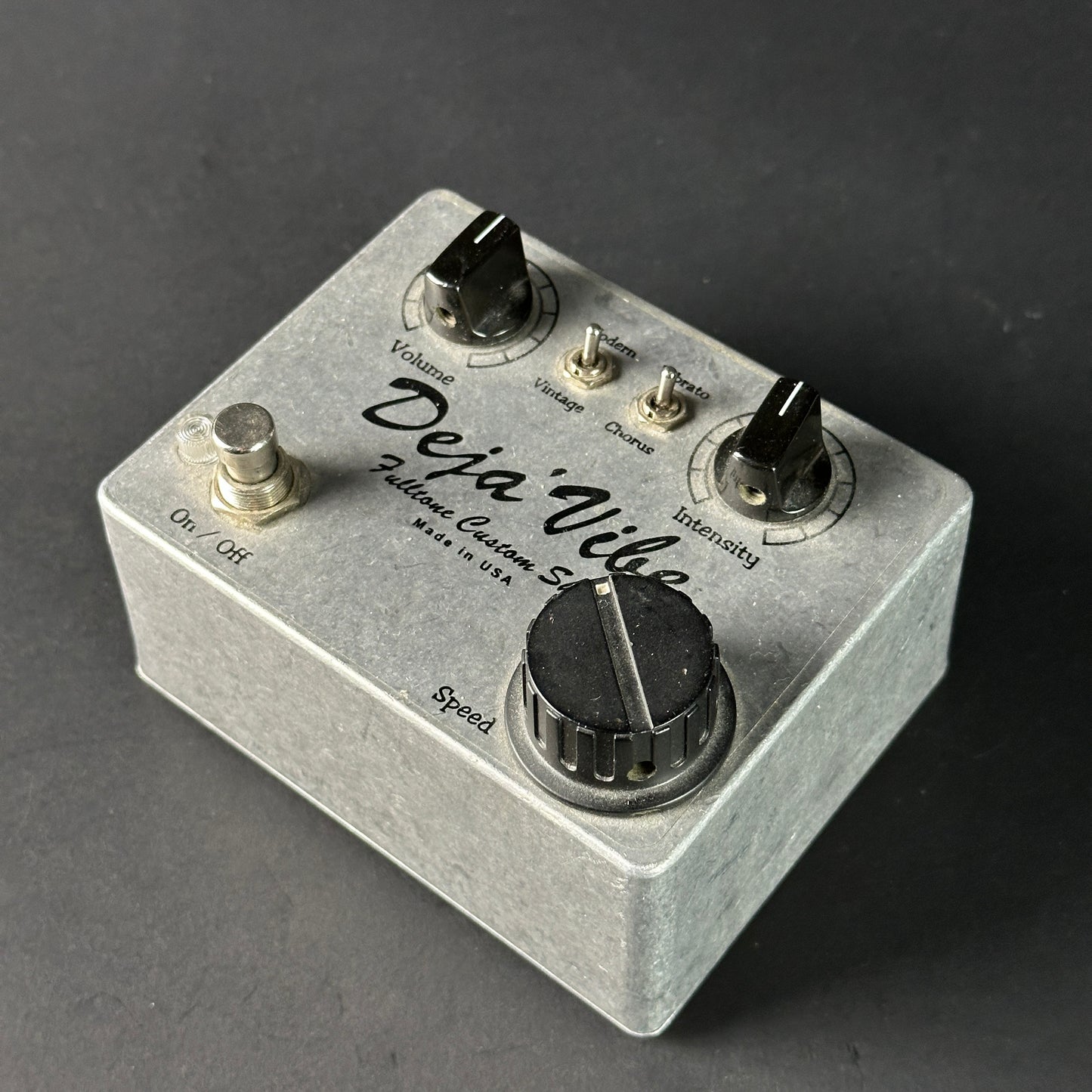 Guitar effects pedal with 'Deja'Vibe' branding on a dark background
