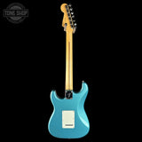 Blue electric guitar with a visible brand logo on a black background