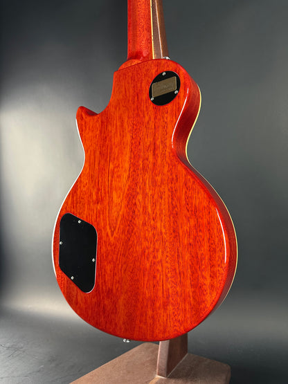 Close-up of a red electric guitar body on a gray background