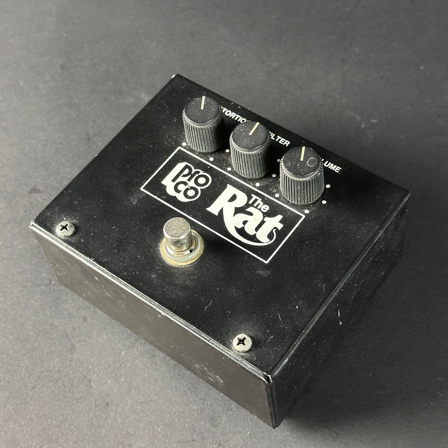Pro Co The Rat guitar effects pedal on a gray background