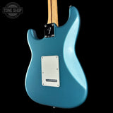 Blue electric guitar with a black background