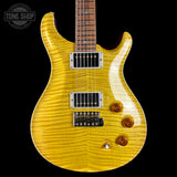 A yellow flamed maple electric guitar with a dark brown neck, chrome hardware, and three control knobs, shown against a solid black background with a Tone Shop watermark in the top left corner.