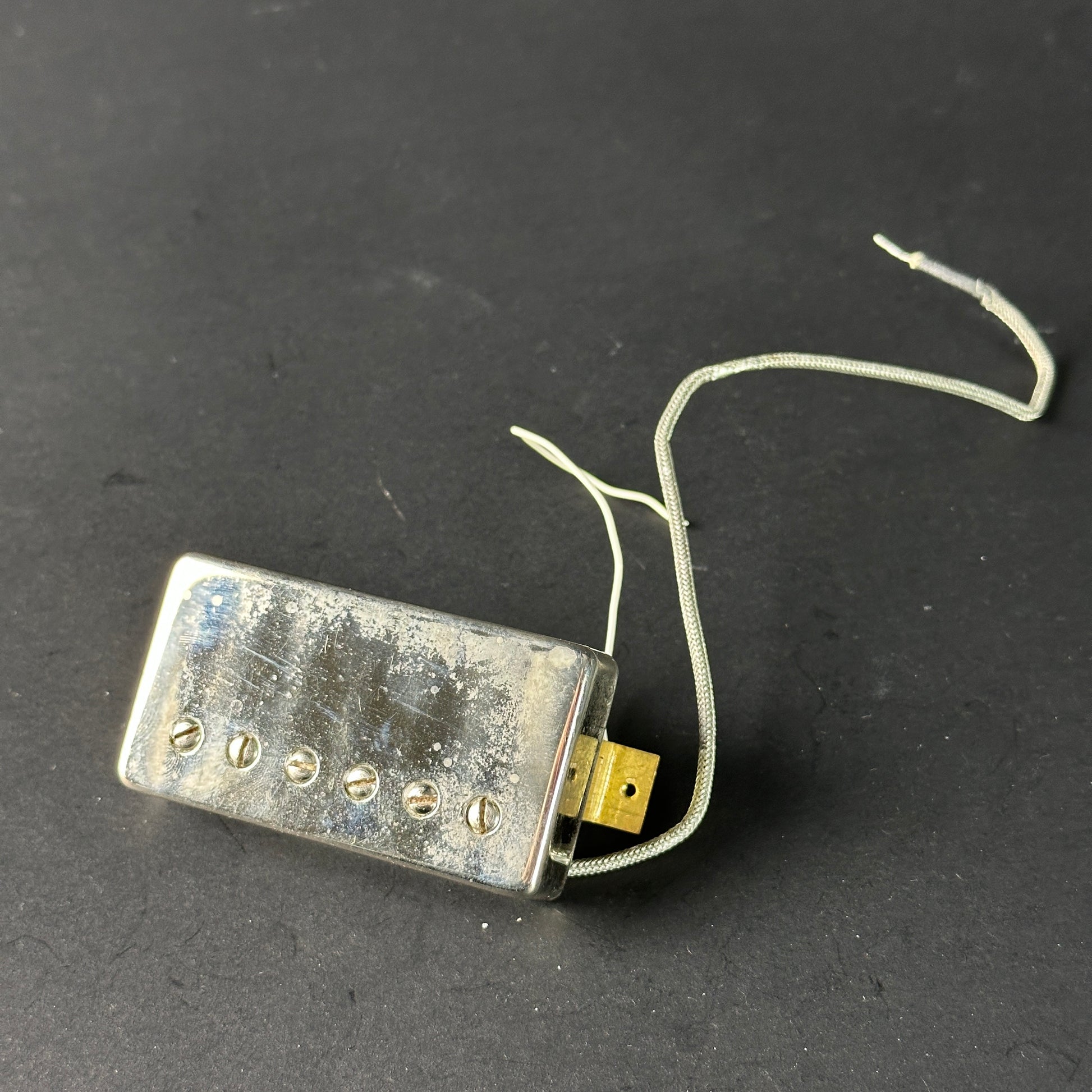 Guitar pickup on a dark gray background