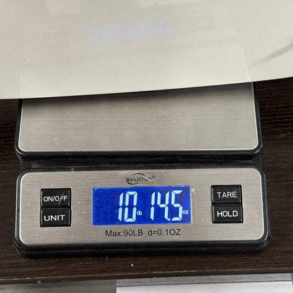 Digital kitchen scale displaying weight on a wooden surface