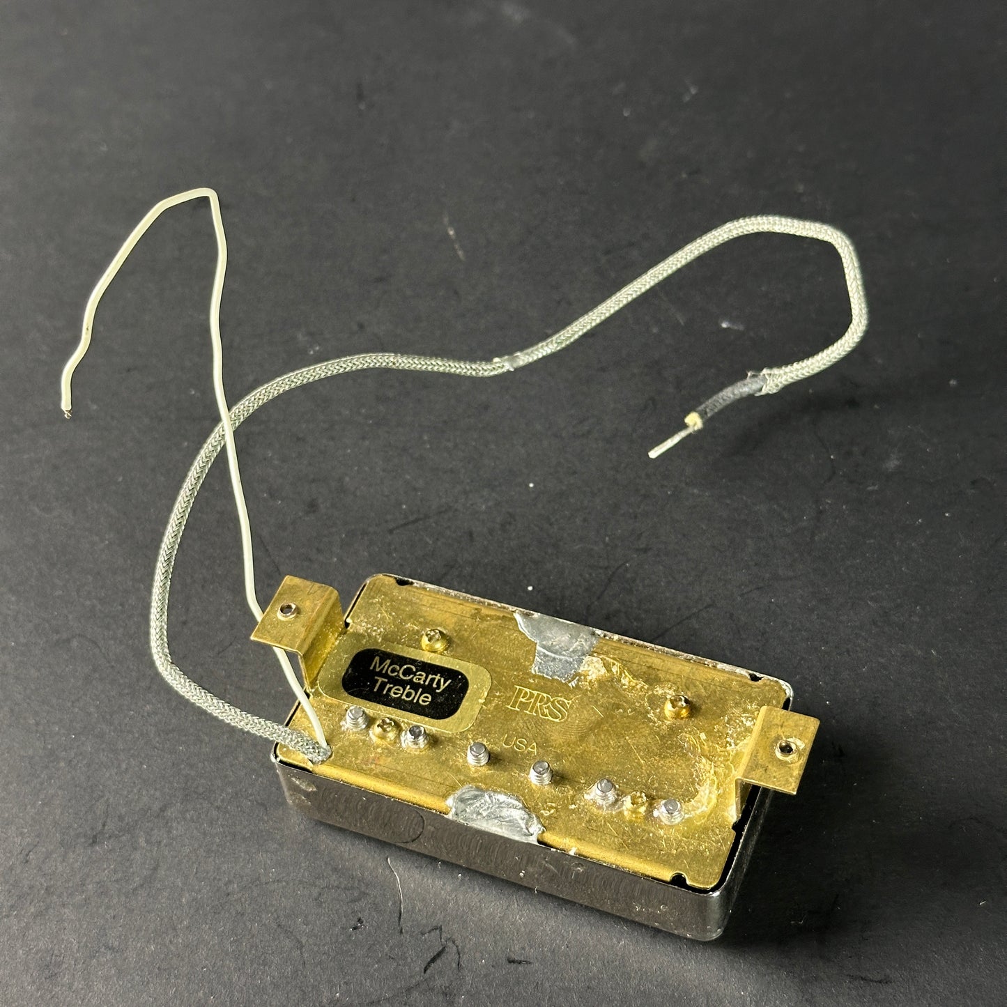 Gold electronic component with wires on a dark background