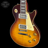 A Gibson Les Paul Custom electric guitar with a natural flame maple top, dark reddish-brown body, cream pickguard, and gold hardware, shown against a black background with a Tone Shop watermark.