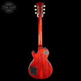A red electric guitar shown from the back against a solid black background, with a Tone Shop watermark in the upper left corner.