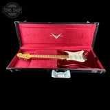 A red electric guitar with a cream pickguard and yellow headstock, displayed inside an open black hard case with a bright red velvet interior. The case lid features a white 'Custom Hard' logo.