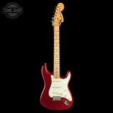 A Fender Stratocaster electric guitar with a glittery red body, maple neck, and white pickguard, shown against a solid black background with a Tone Shop watermark in the top-left corner.