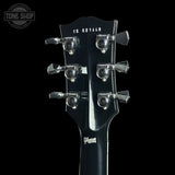 Close-up of the headstock of a Gibson electric guitar, showing six chrome tuning pegs, the model code CS 601448, and the Gibson logo on a black background.