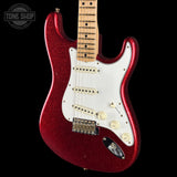 A red glitter electric guitar with a white pickguard and maple neck, photographed against a solid black background. A Tone Shop watermark is visible in the top-left corner.