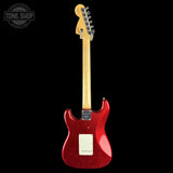 A red glitter electric guitar shown from the back against a solid black background, with a Tone Shop watermark in the upper left corner.