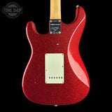 The back of a red glitter electric guitar with a maple neck, shown against a solid black background. A Tone Shop watermark is visible in the top-left corner.