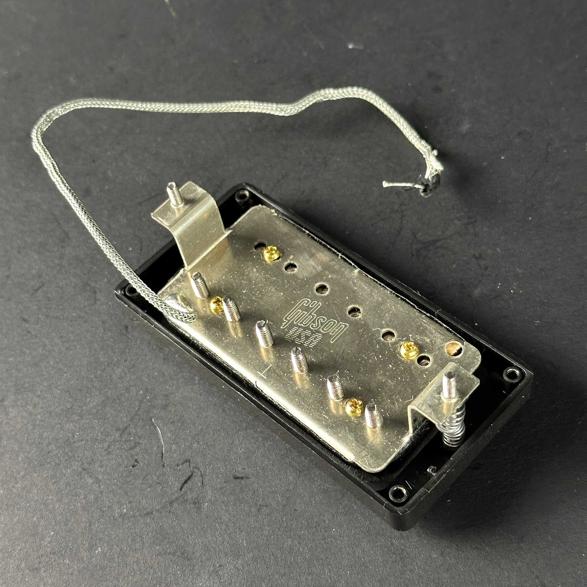 Gibson guitar pickup on a dark background