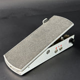 Guitar pedal with textured surface on a black background