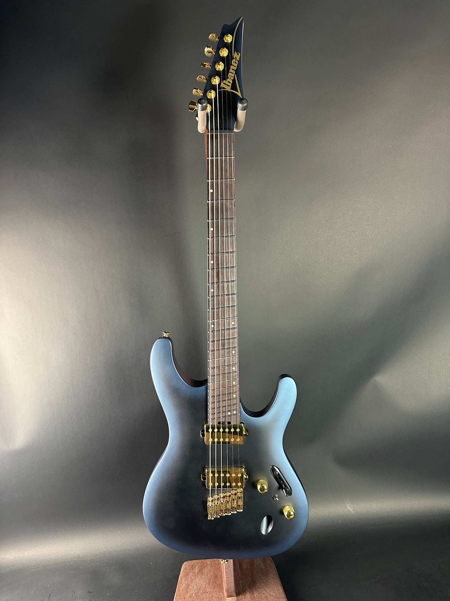 Electric guitar with a blue body on a gray background