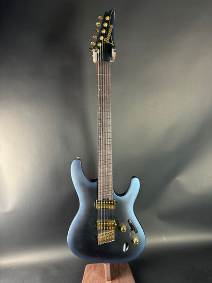 Electric guitar with a blue body on a gray background