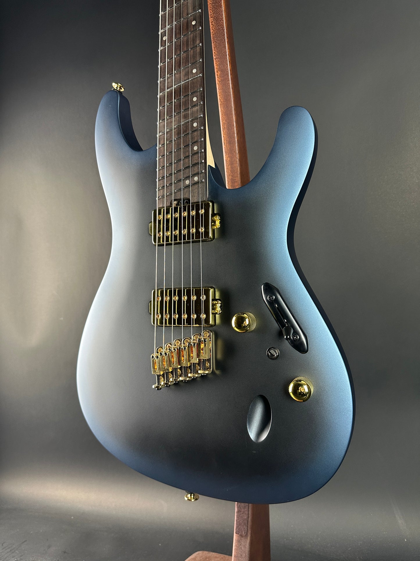 Blue electric guitar on a gray background