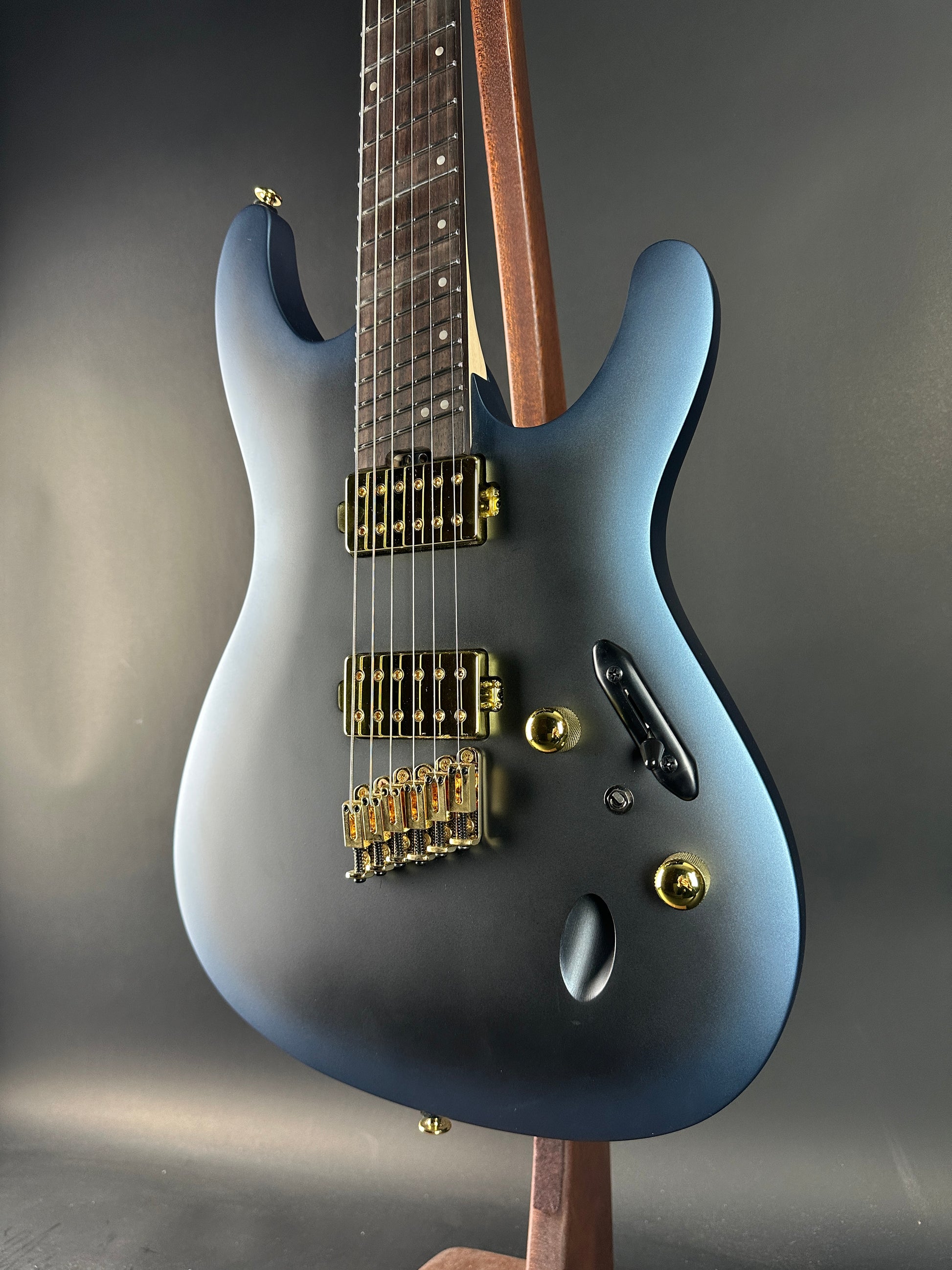 Blue electric guitar on a gray background