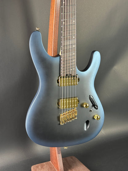 Blue electric guitar on a dark gray background