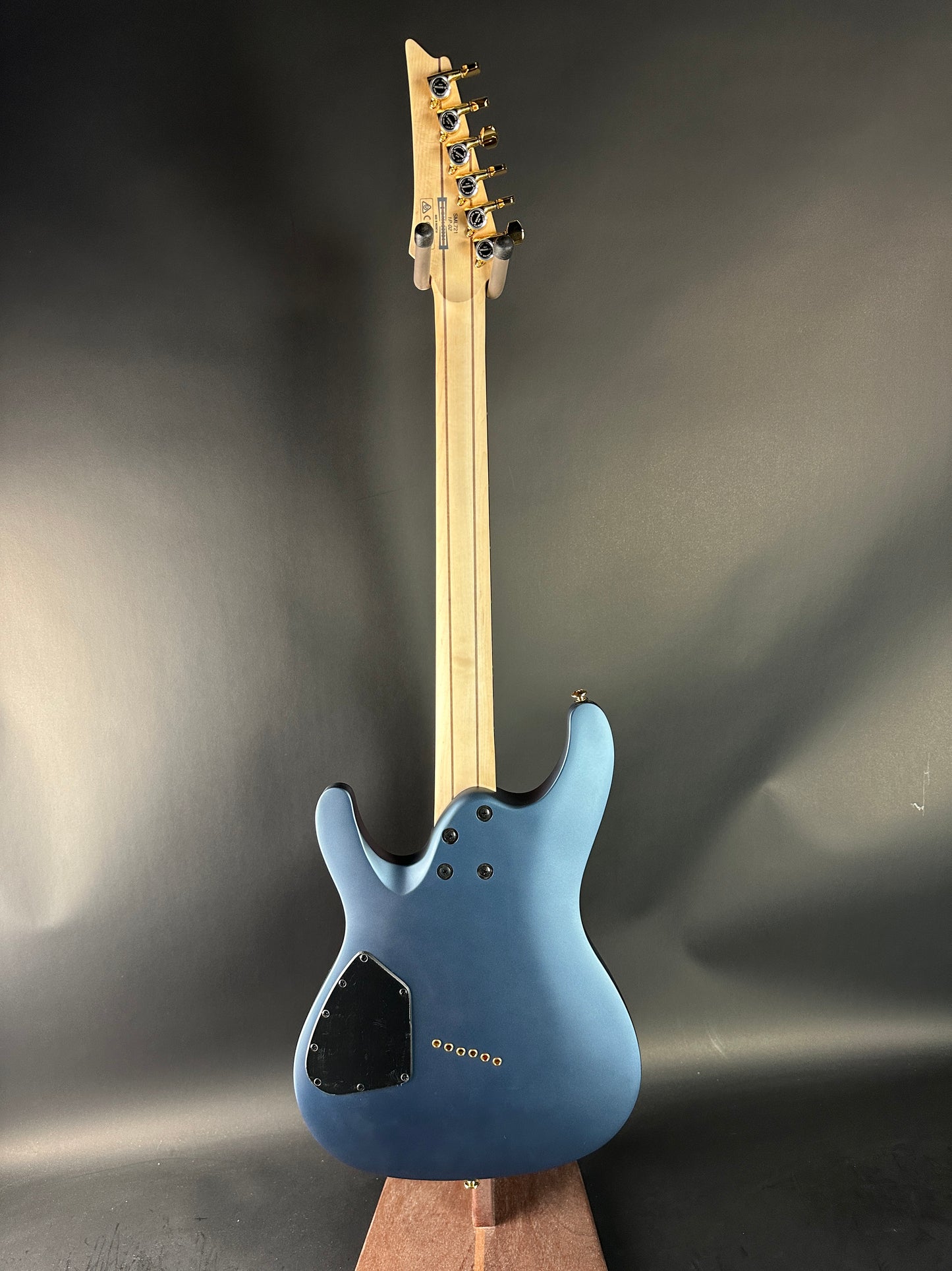 Blue electric guitar on a dark gray background