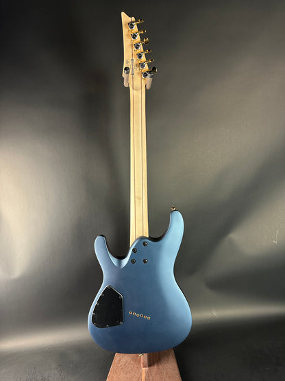 Blue electric guitar on a dark gray background