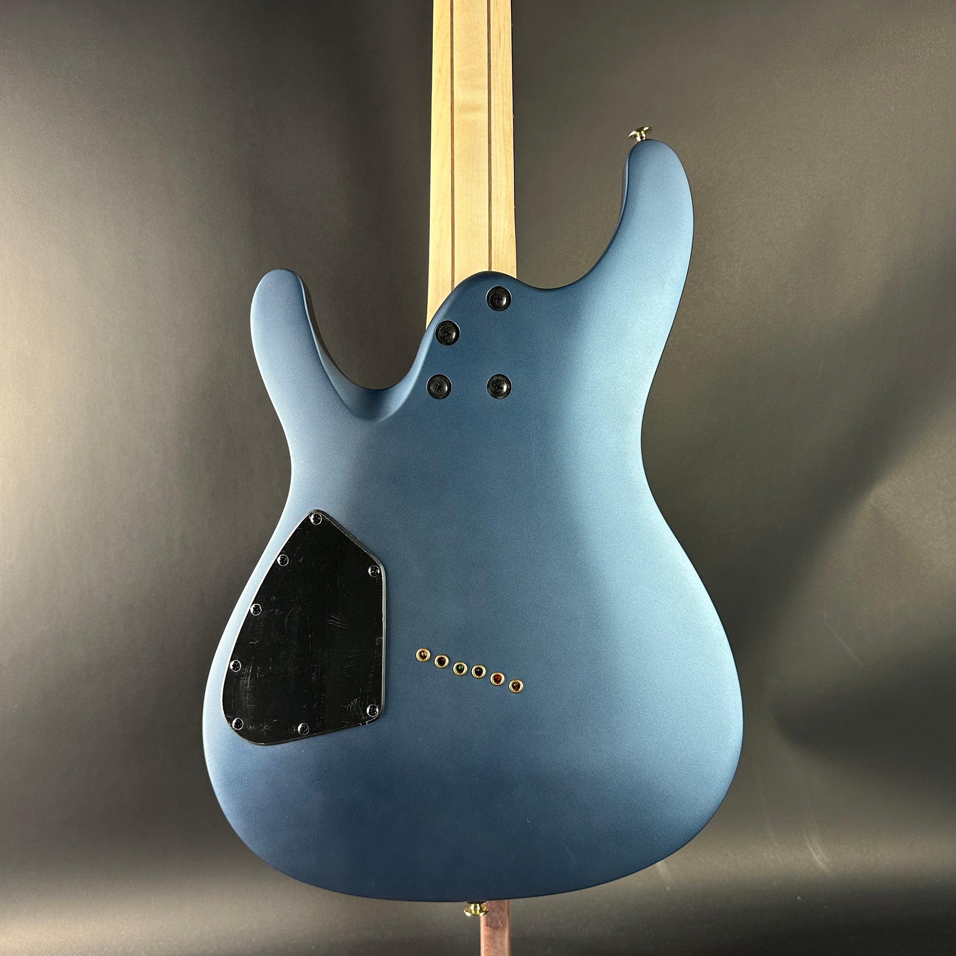 Blue electric guitar on a gray background