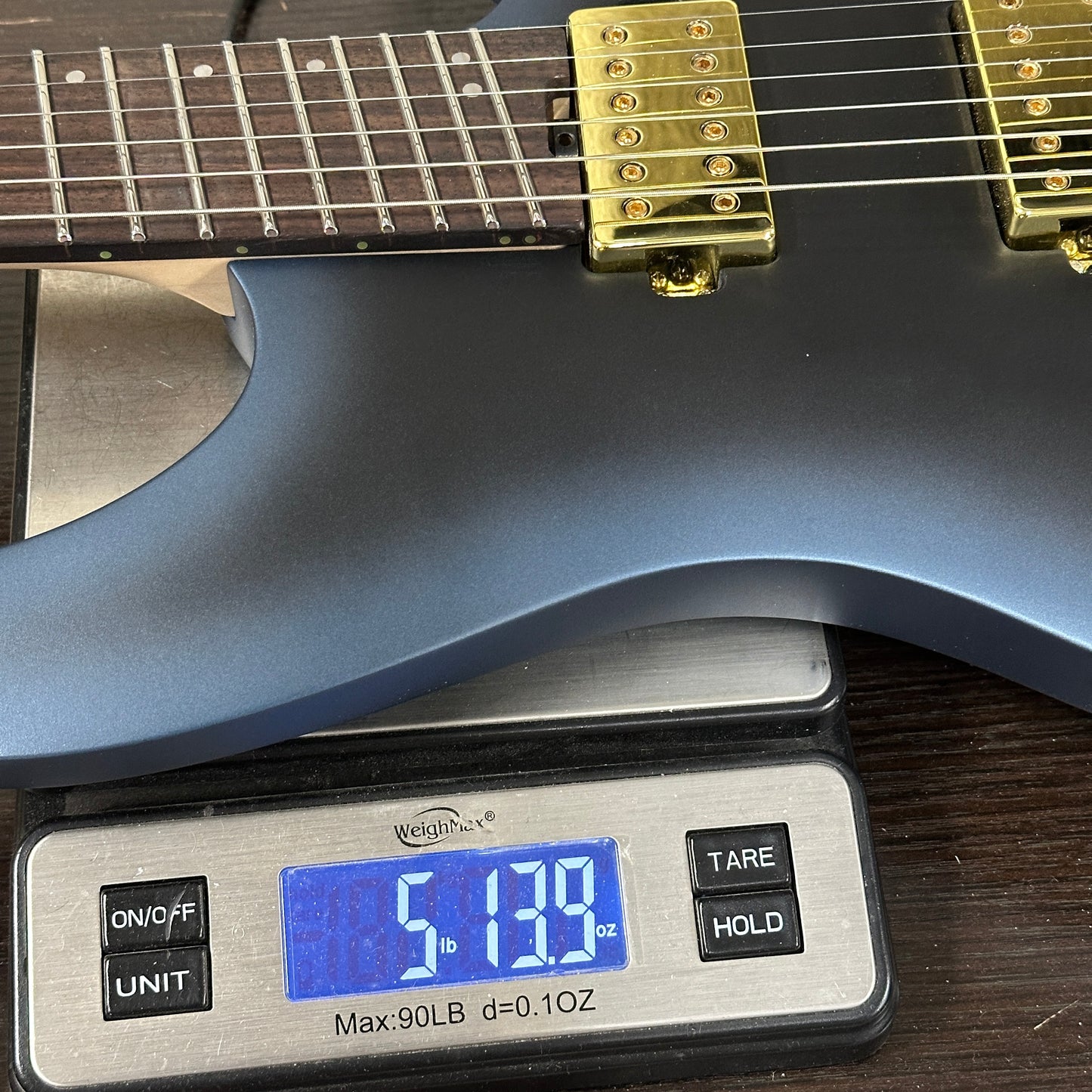 Guitar on a digital scale displaying weight