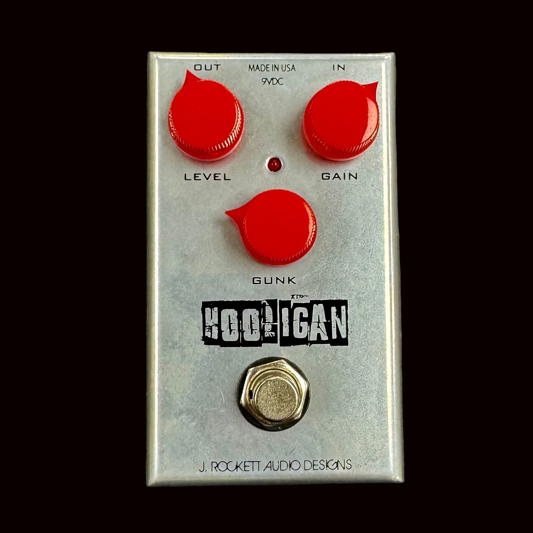 Guitar effects pedal with red knobs and 'J. Rockett Audio Designs' branding on a gray background