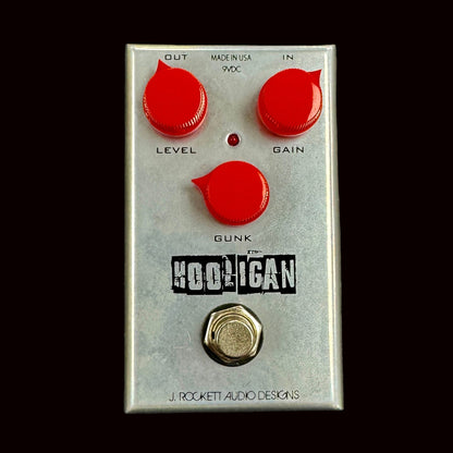 Guitar effects pedal with red knobs and 'J. Rockett Audio Designs' branding on a gray background