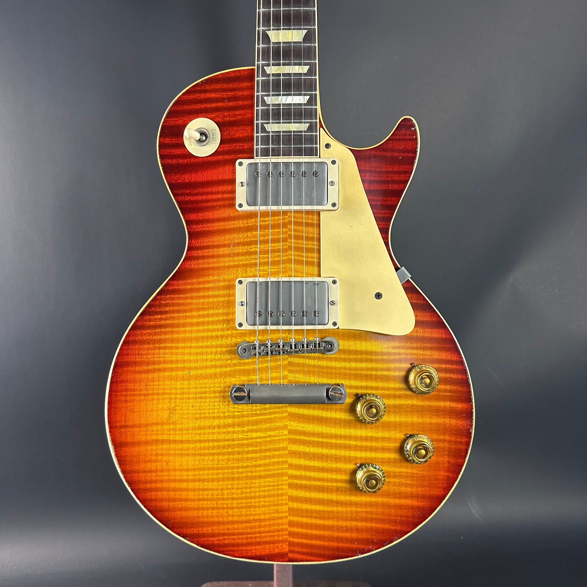 Electric guitar with a sunburst finish on a dark background