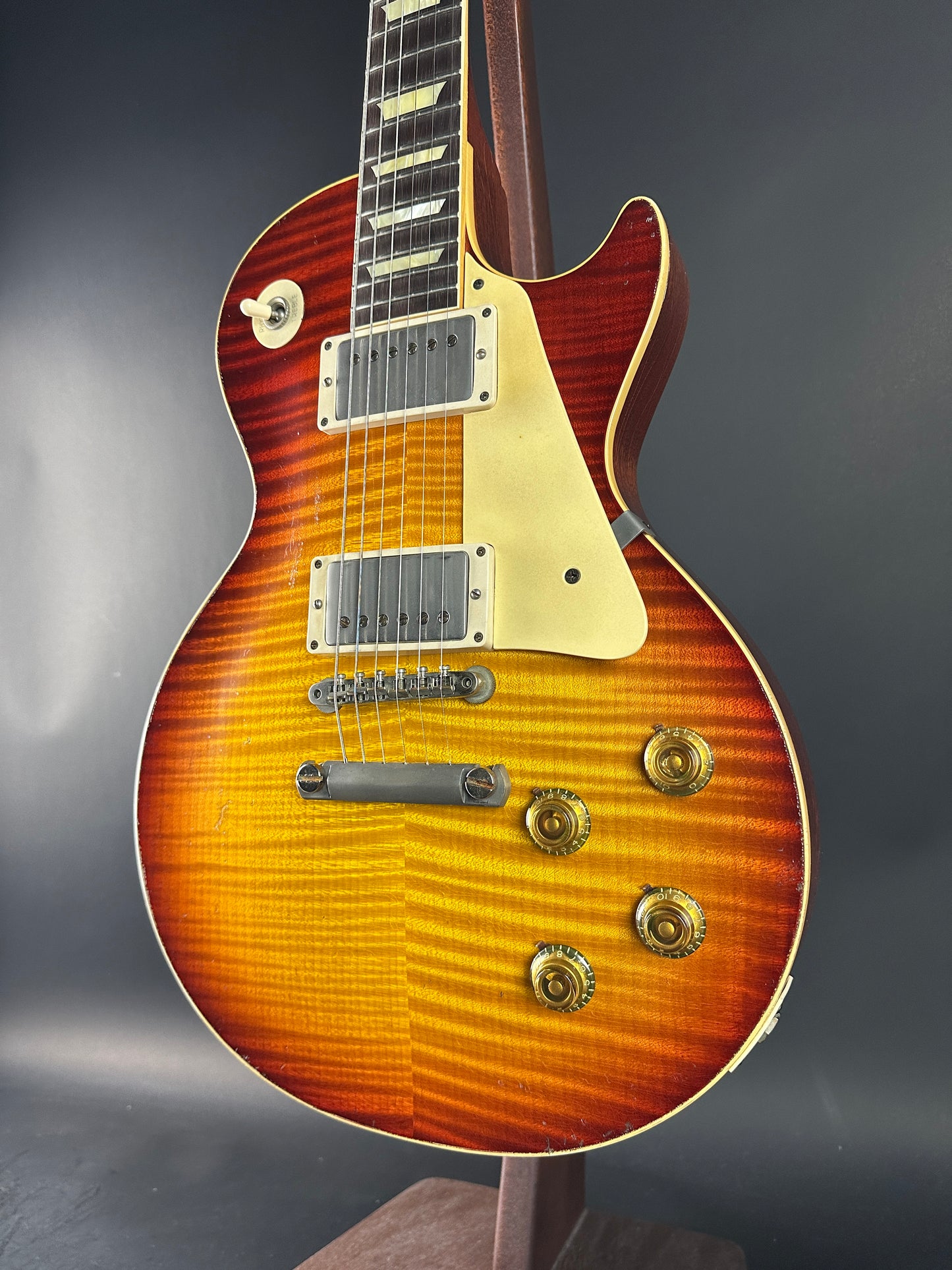 Electric guitar with a sunburst finish on a dark background